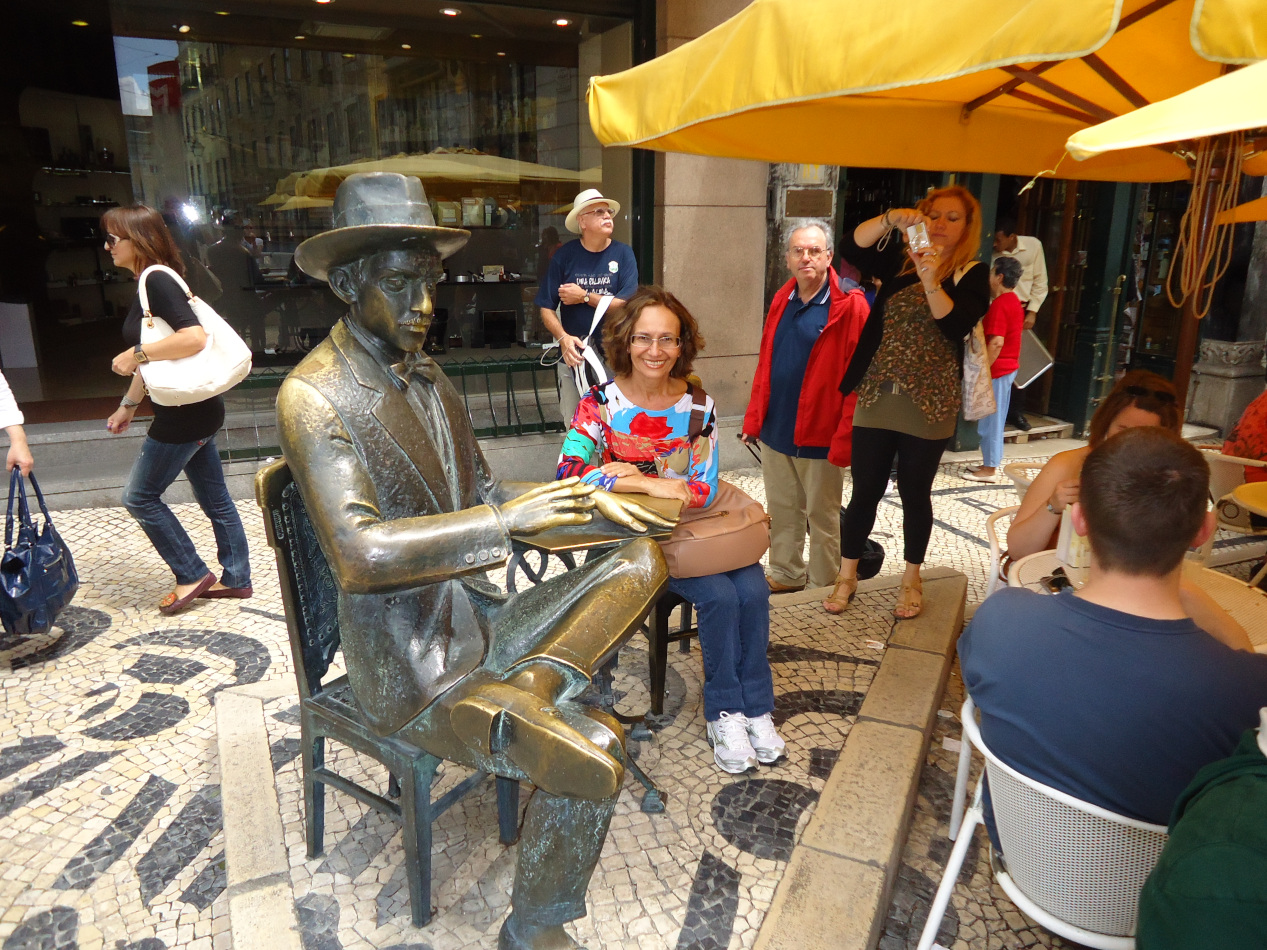 Me sitting with the statue of Fernando Pessoa in Lisbon.
